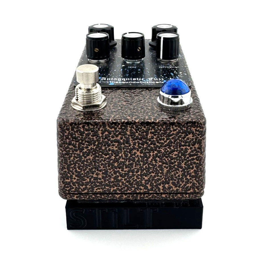 The STILT Pedal Riser from Nicholls Custom Designs being used to give lift to an Antagonistic Fuzz from The Sound Of Justice