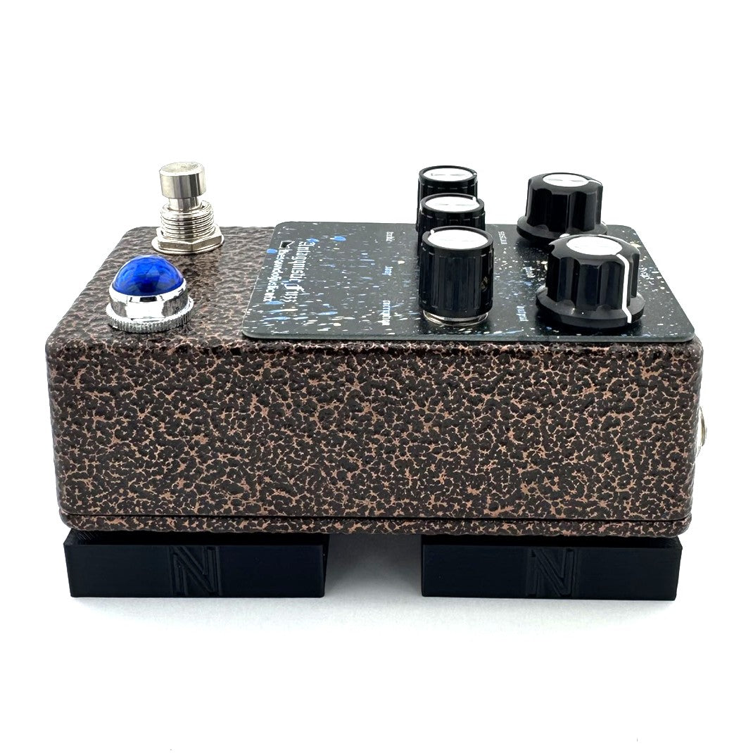 The STILT Pedal Riser from Nicholls Custom Designs being used to give lift to an Antagonistic Fuzz from The Sound Of Justice